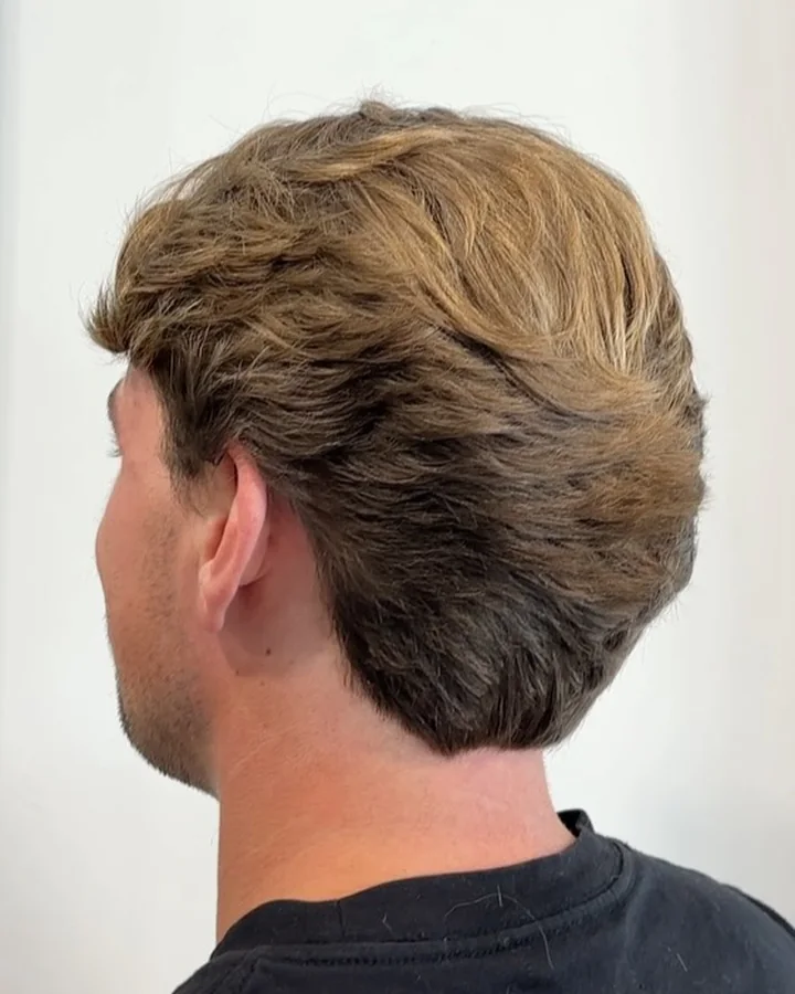 Back and side view of a softly textured men’s haircut